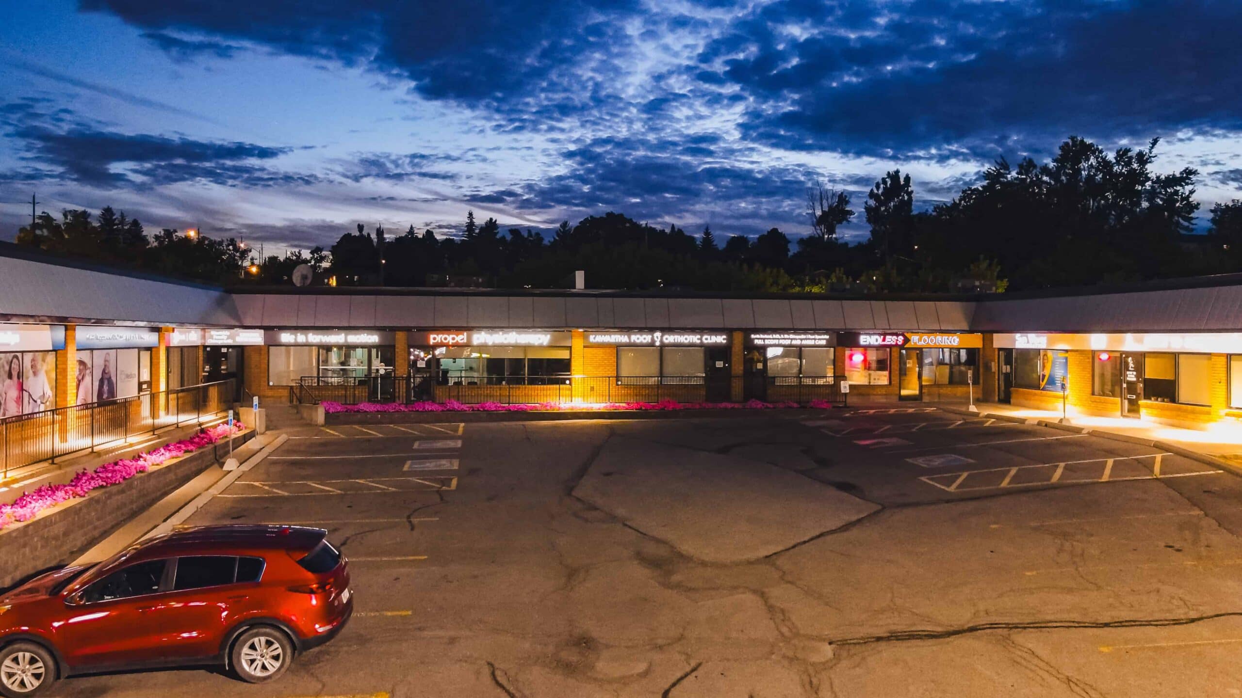 Modern retail plaza at dusk in Peterborough, Ontario, showcasing professional commercial photography.