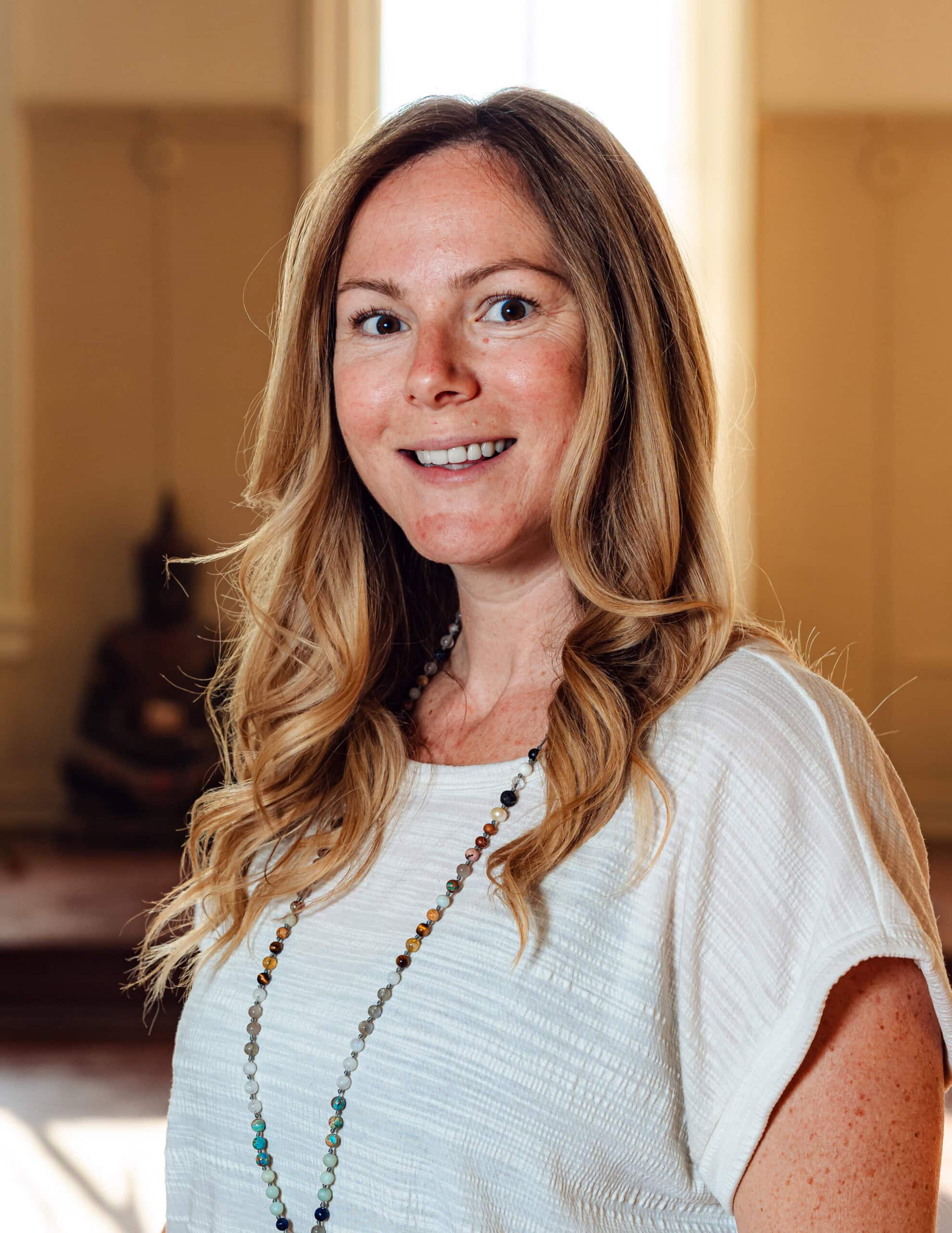 Evan Aube Creative portrait of a woman smiling indoors, showcasing professional branding.